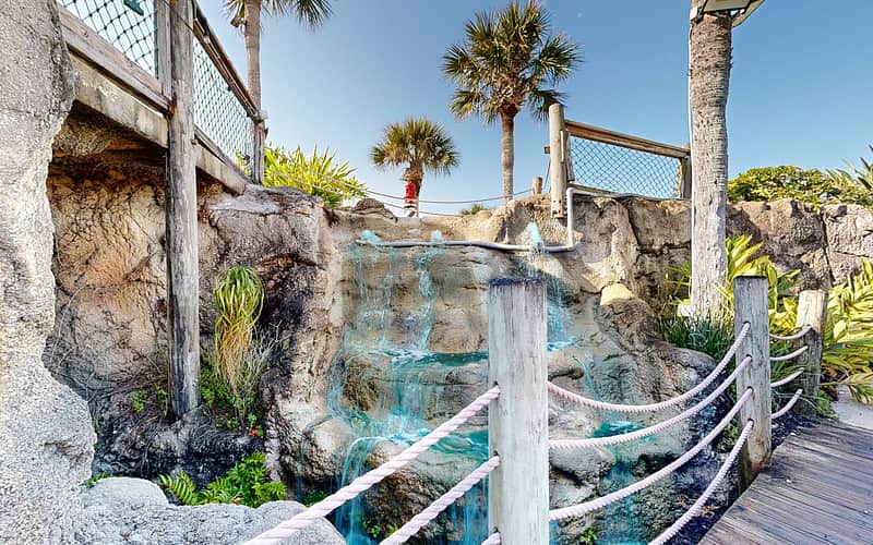 The giant central grotto waterfall cascading down the rocks into the lagoon